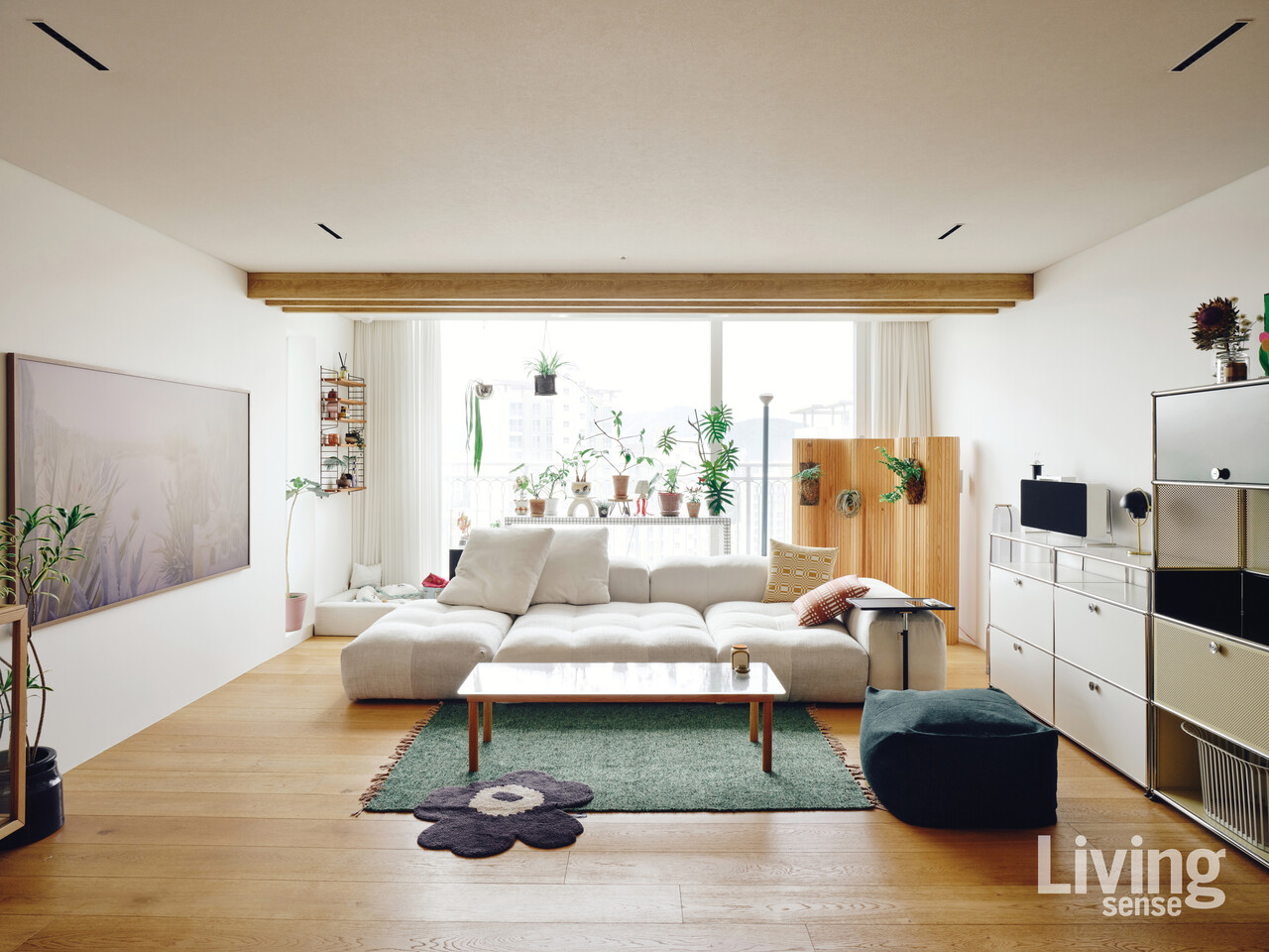 사바 이탈리아Saba Italia의 픽셀 모듈 소파Pixel Module Sofa를 놓은 거실. 플랜테리어로 자연적인 분위기를 더했다. 화분을 놓은 테이블은 타일을 붙여 만든 것. 아르텍Artek의 룸 디바이더 스크린 100Screen 100을 활용해 식물을 걸어두었다.